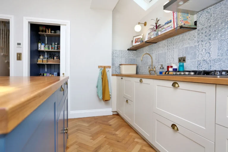 Kitchen worktop and pantry beside the blue island — Chiswick W4