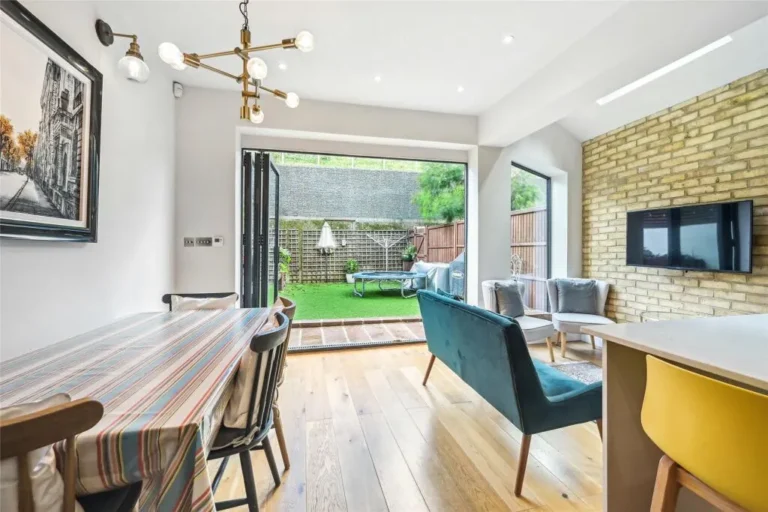Dining and seating area beside an exposed brick wall — Chiswick W4