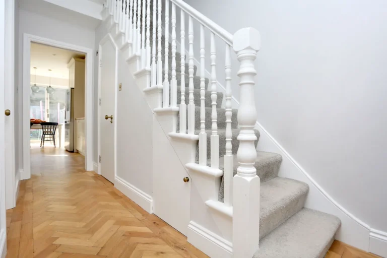 Hallway with parquet floor and white staircase — Chiswick W4