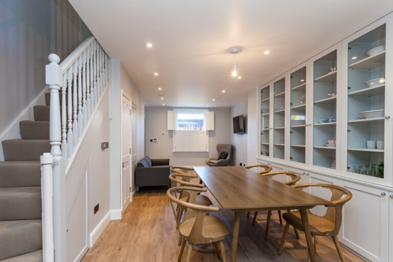Dining area beside timber staircase and kitchen — Marylebone NW1
