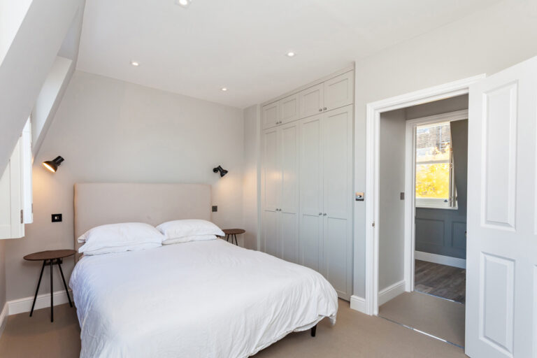 Bedroom with fitted cupboards and en suite doorway — Marylebone NW1