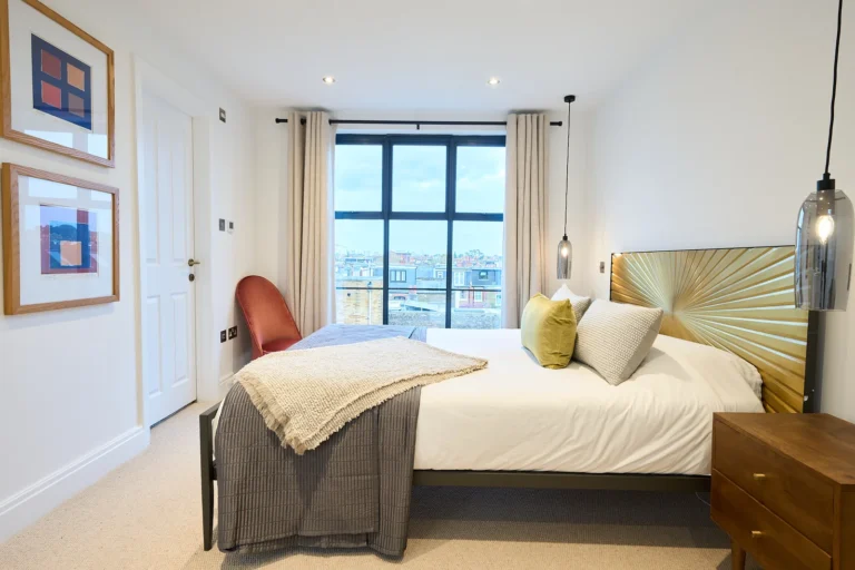 Modern bedroom with large window and stylish decor — Chiswick W4