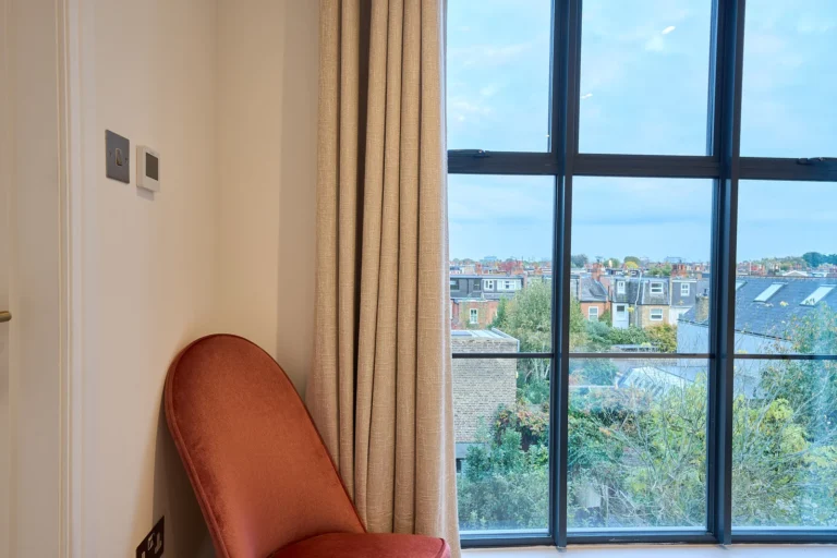 Chair by window with city view — Chiswick W4