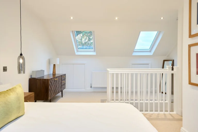 Bright loft bedroom with skylights and dresser — Chiswick W4
