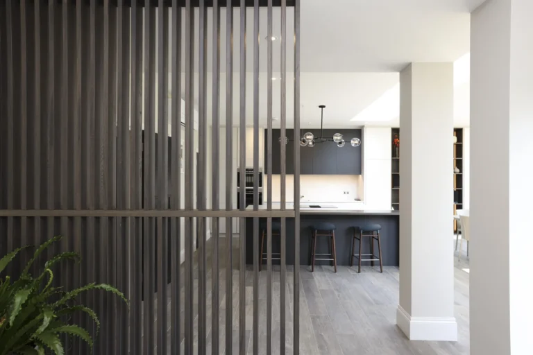 Modern kitchen interior with wooden partition and barstools — Sheen SW14