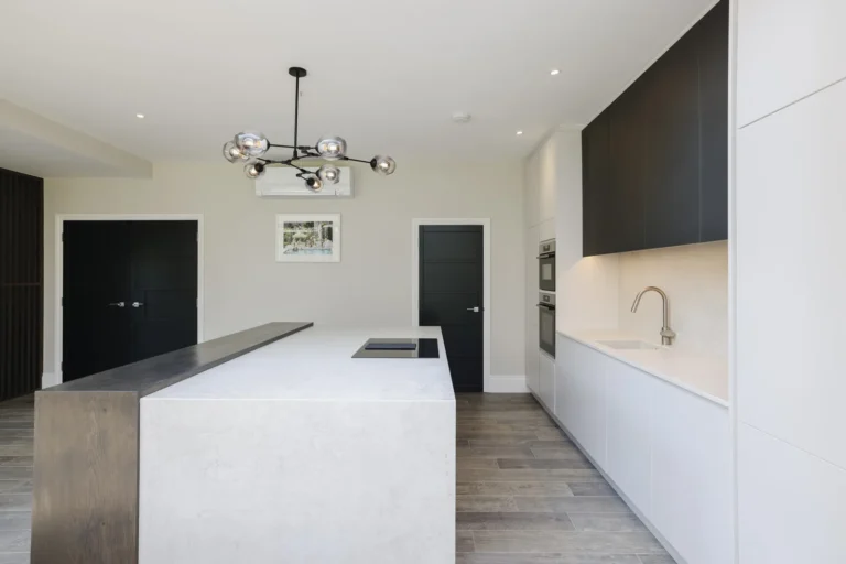 Modern kitchen with large island and pendant lights — Sheen SW14