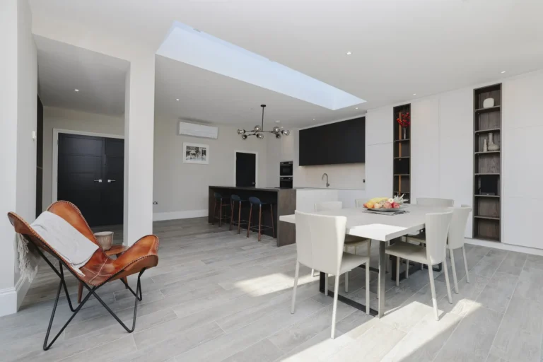Modern open-plan kitchen with dining area and skylight — Sheen SW14