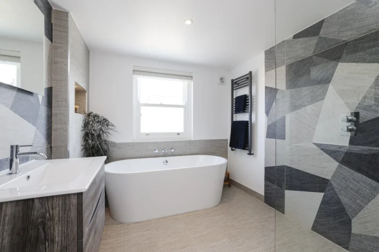 Modern bathroom with bathtub and geometric tiles — Sheen SW14