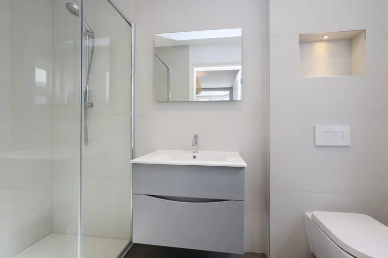 Modern white bathroom with glass shower, sink, toilet — Sheen SW14