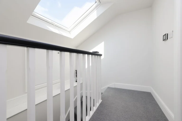 Bright stairway with skylight and carpeted steps — Sheen SW14
