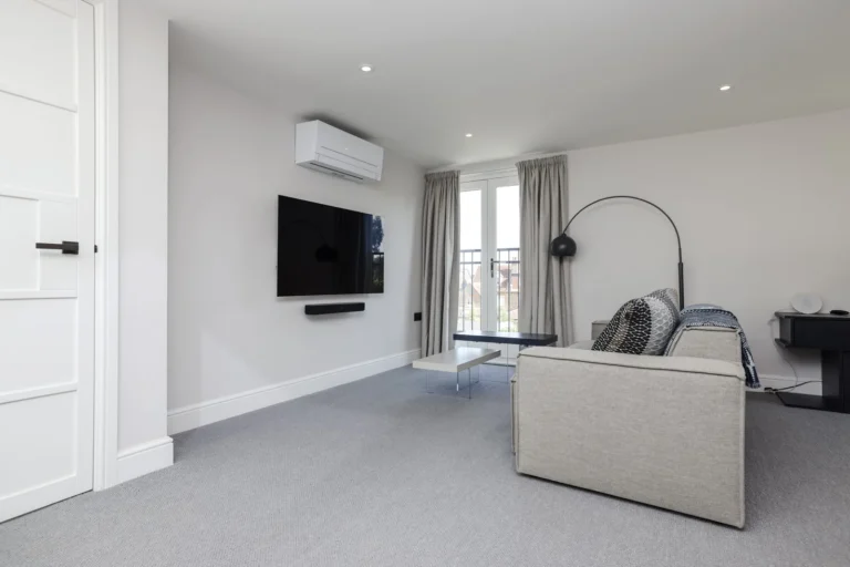 Seating area with a wall-mounted television within the loft suite — Sheen SW14