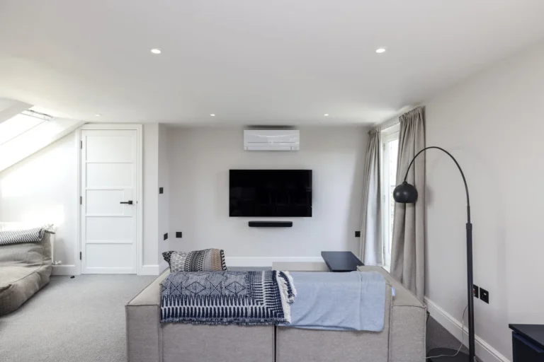 Loft suite seating area with sofa and wall-mounted television — Sheen SW14