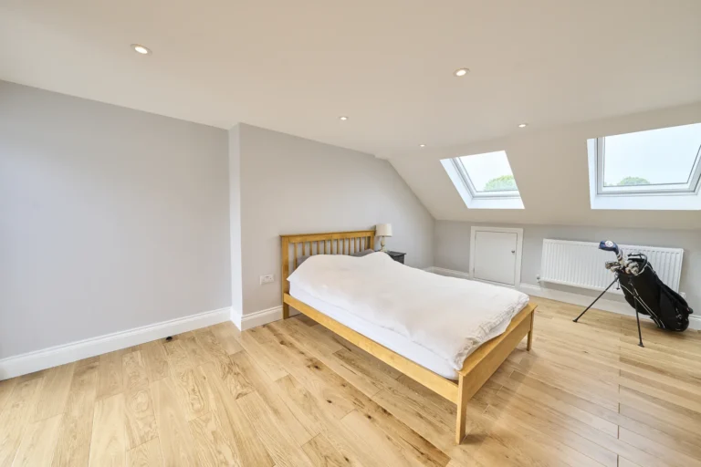 Cosy loft bedroom with skylights and wooden floor — Kennington SE17