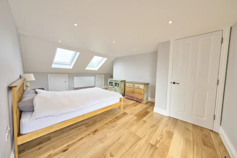 Bright loft bedroom with skylights and wooden floor — Kennington SE17
