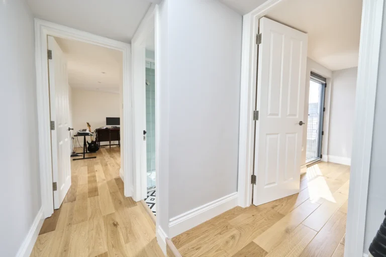 Bright hallway with wooden floor and open doors — Kennington SE17