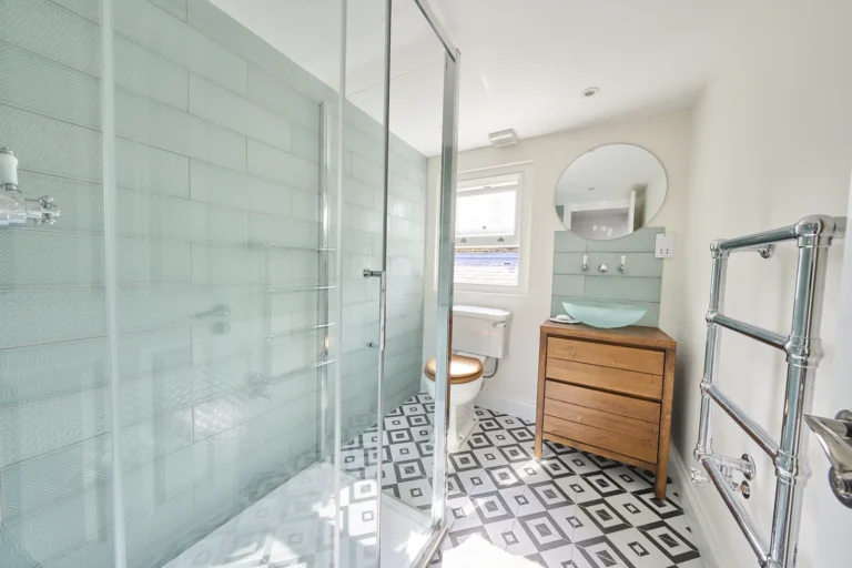 Modern bathroom with shower and geometric floor tiles — Kennington SE17