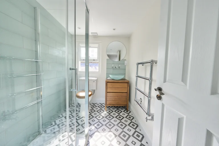 Modern bathroom with glass shower and patterned floor — Kennington SE17
