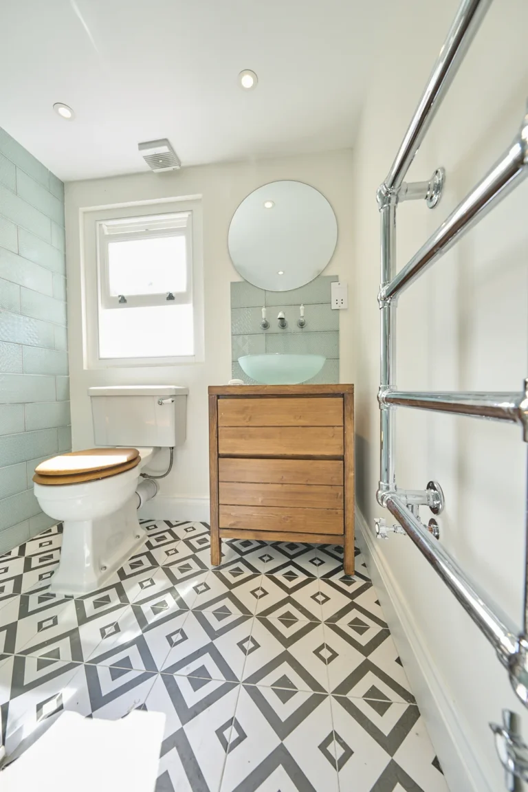 Modern bathroom with geometric tiled floor — Kennington SE17