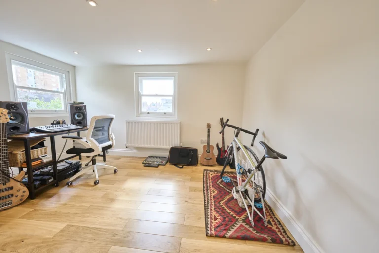Home studio with desk, chair, guitars, bike — Kennington SE17
