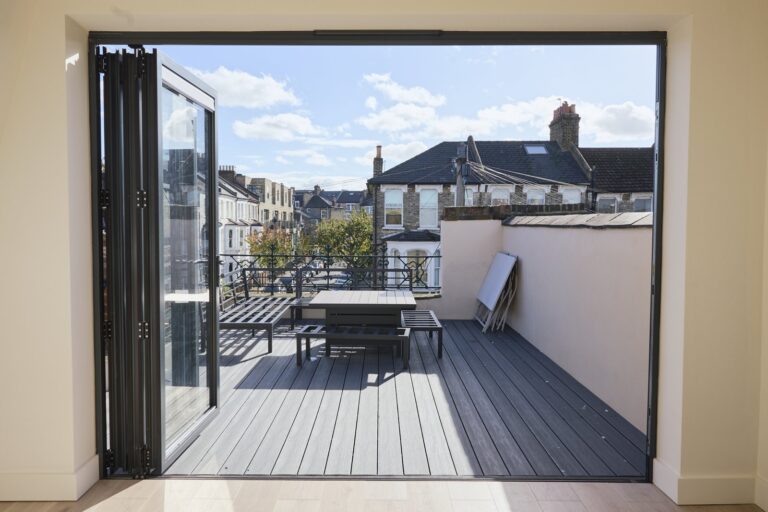 Open folding doors leading from the loft to a decked roof terrace — Clapham SW11