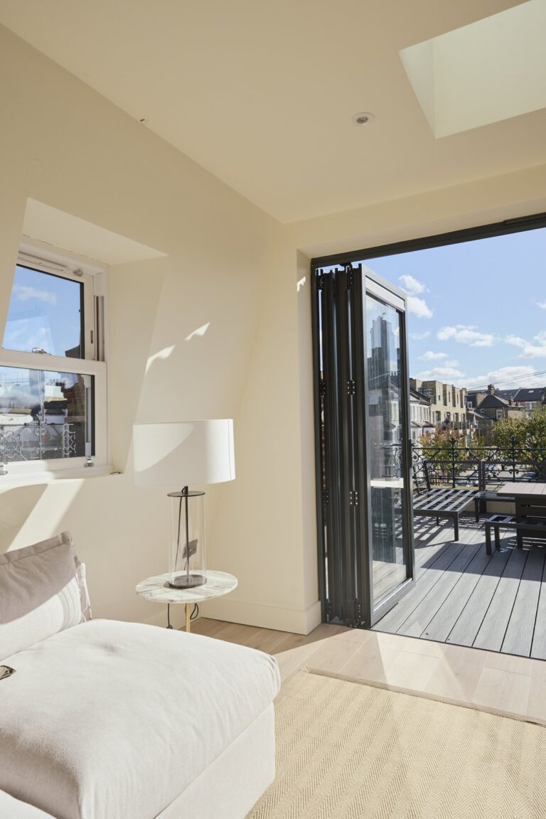 Loft seating and floor lamp beside the terrace doorway — Clapham SW11