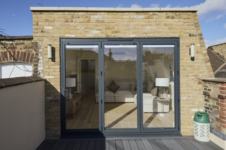 Brick loft extension with black-framed terrace glazing — Clapham SW11