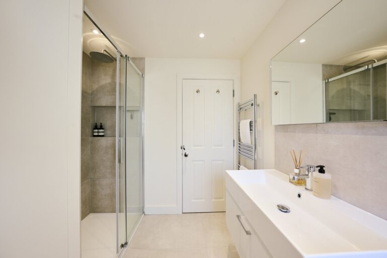 Loft shower room with glass enclosure and fitted vanity — Clapham SW11
