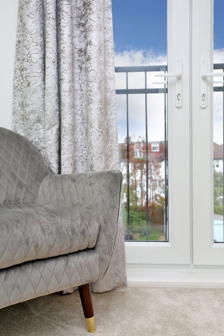 Gray quilted sofa near patio door and curtains β Morden SM4