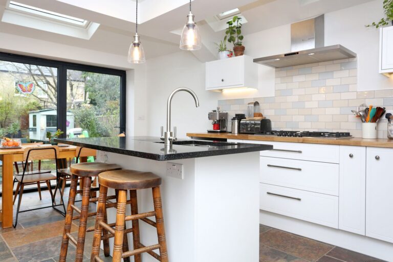 Modern kitchen with island and wooden stools — Isleworth TW7