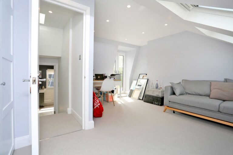 Bright loft room with sofa, desk, and decor — Hammersmith W6