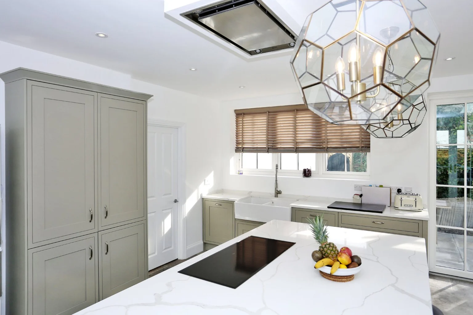 Modern kitchen with island and large light fixture — Acton W3
