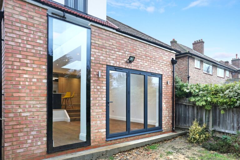 Modern brick house with large glass doors — Acton W3