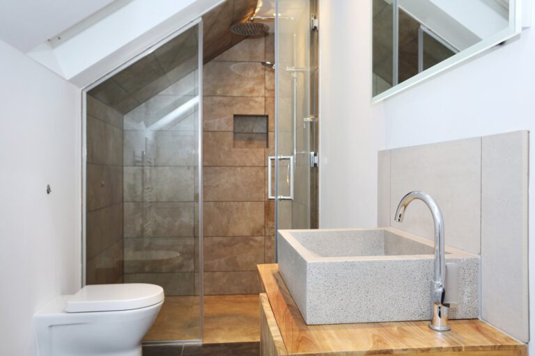 Loft bathroom with a rectangular basin, timber vanity and glass shower enclosure — Acton W3