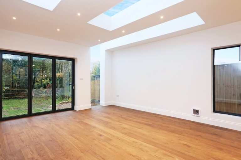 Empty room with skylights and sliding glass doors — Acton W3