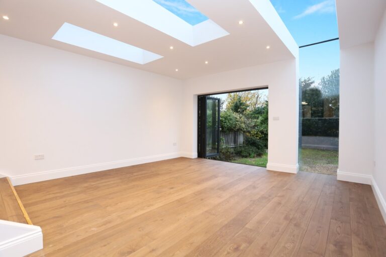 Bright empty room with wooden floor and skylight — Acton W3