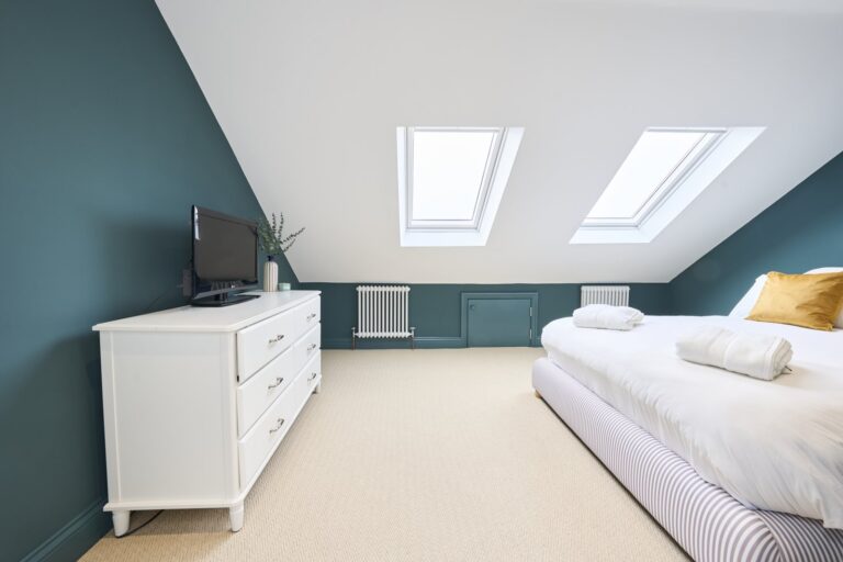 Bright loft bedroom with skylights and dresser — Balham SW12
