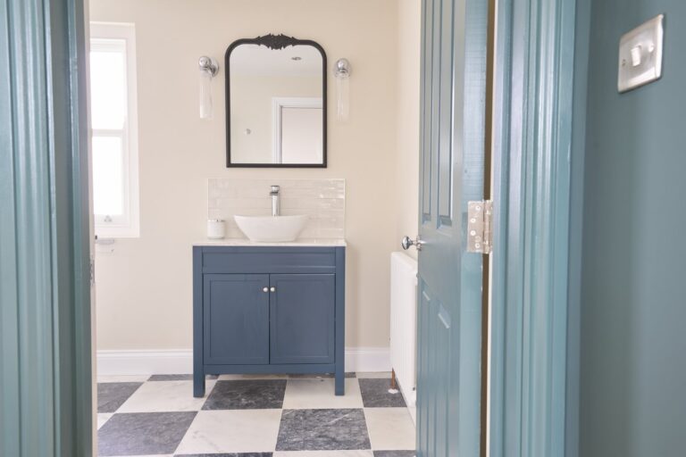 Modern bathroom with blue vanity and mirror — Balham SW12