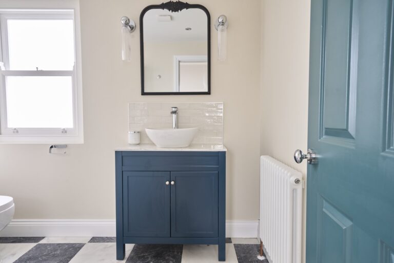 Modern bathroom with blue vanity and mirror — Balham SW12