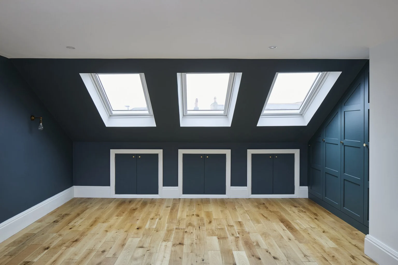Empty loft room with skylights and wooden floor — Tooting SW17