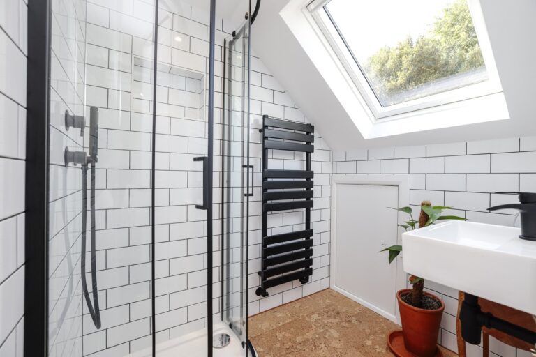 Modern bathroom with skylight and glass shower — Acton W3