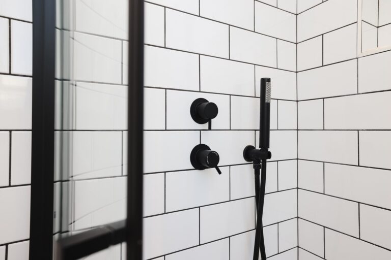 Black shower fixtures on white subway tiles — Acton W3