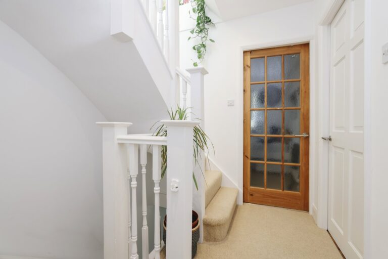 Bright hallway with stairs and wooden door — Acton W3