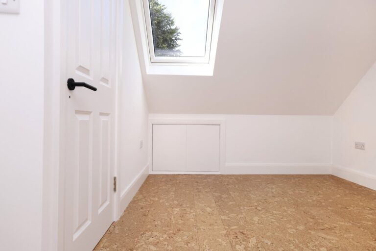 Loft room with rooflight, white door and cork flooring — Acton W3