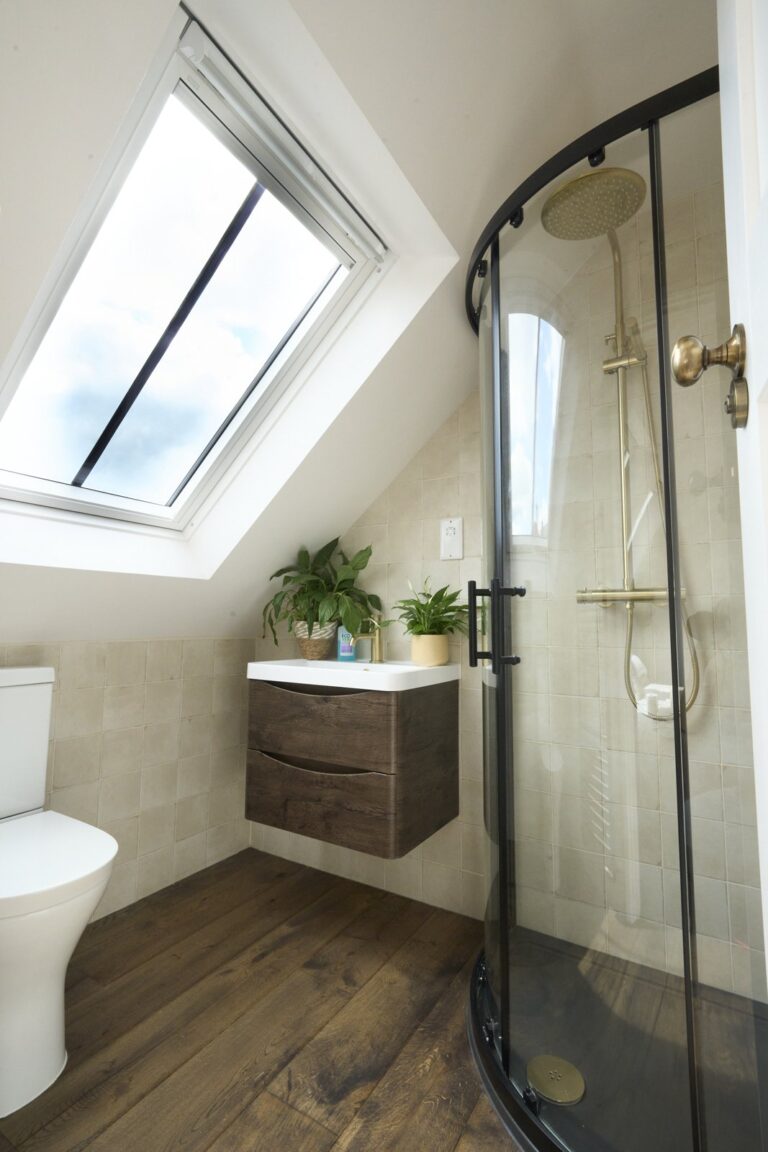 Modern loft bathroom with skylight and glass shower — Chiswick W4