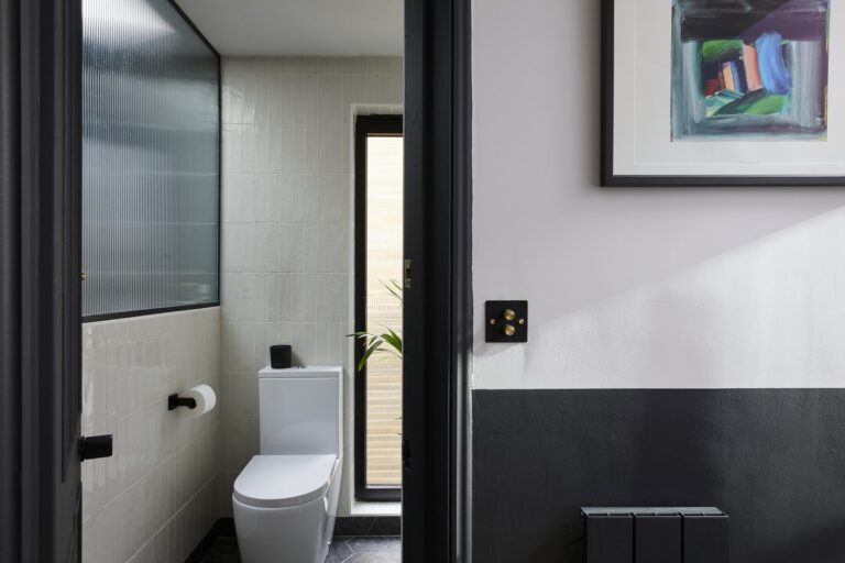 Modern bathroom with toilet and tiled walls — Tooting SW17