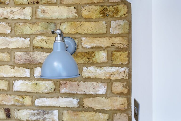 Blue sconce lamp on a brick wall — Fulham SW6