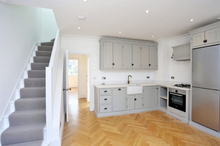 Modern kitchen with staircase and wooden flooring — Fulham SW6