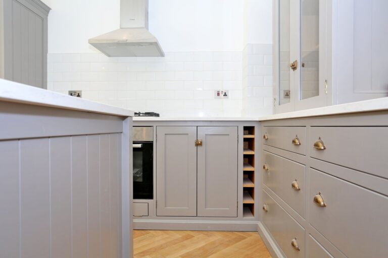 Modern kitchen with gray cabinets and wood flooring — Fulham SW6