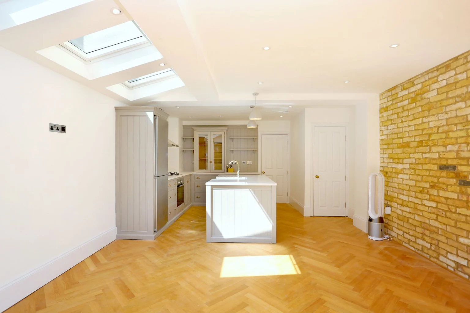 Bright kitchen with skylights and wooden floor — Fulham SW6