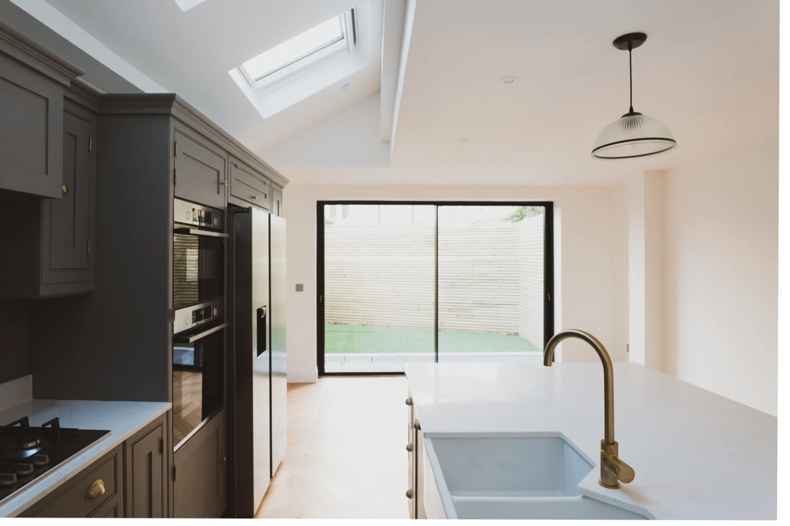 Modern kitchen with skylight and sliding doors — Fulham SW6